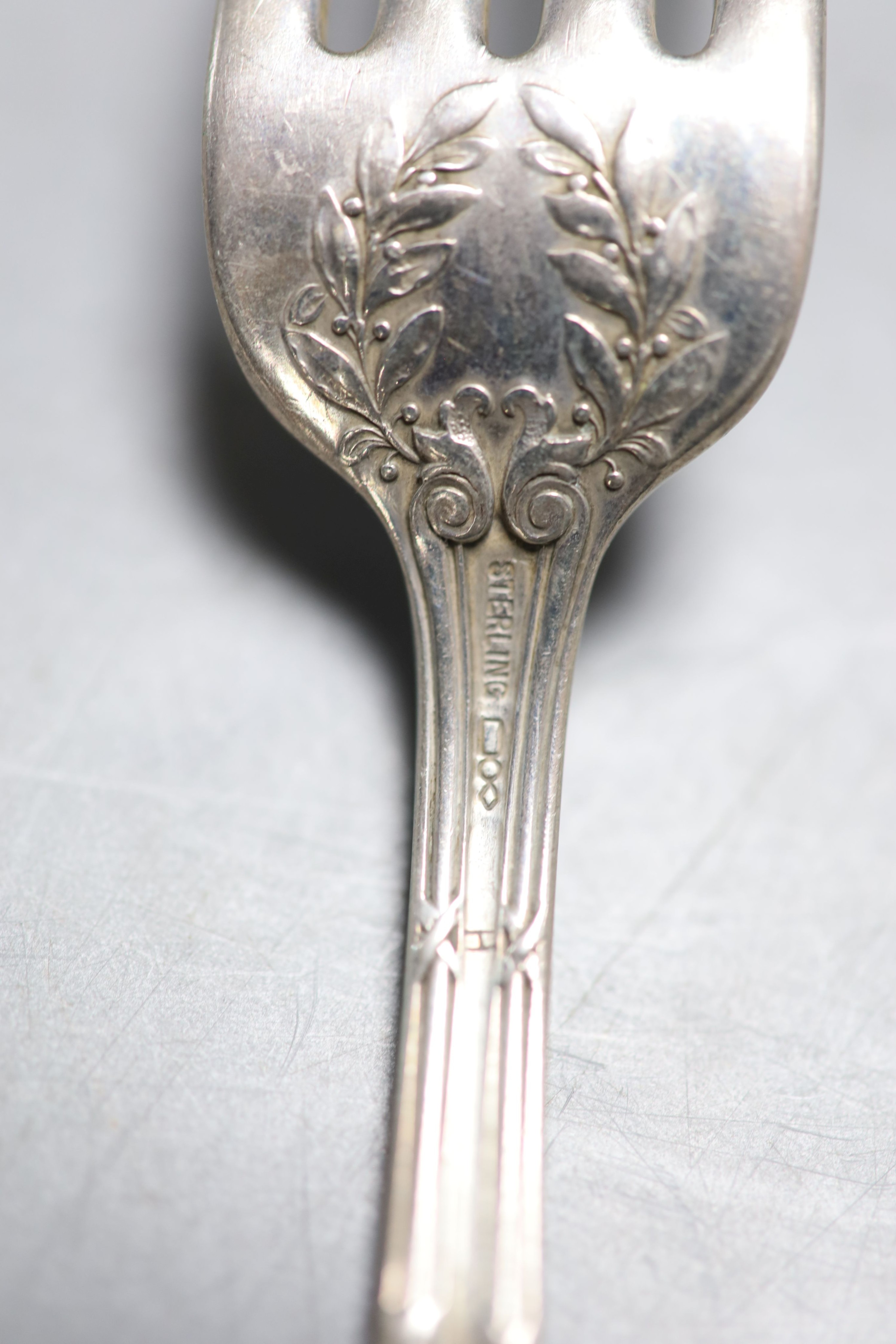 Four American sterling iced tea spoons, signed Cartier and a similar set of four table forks, 13oz.